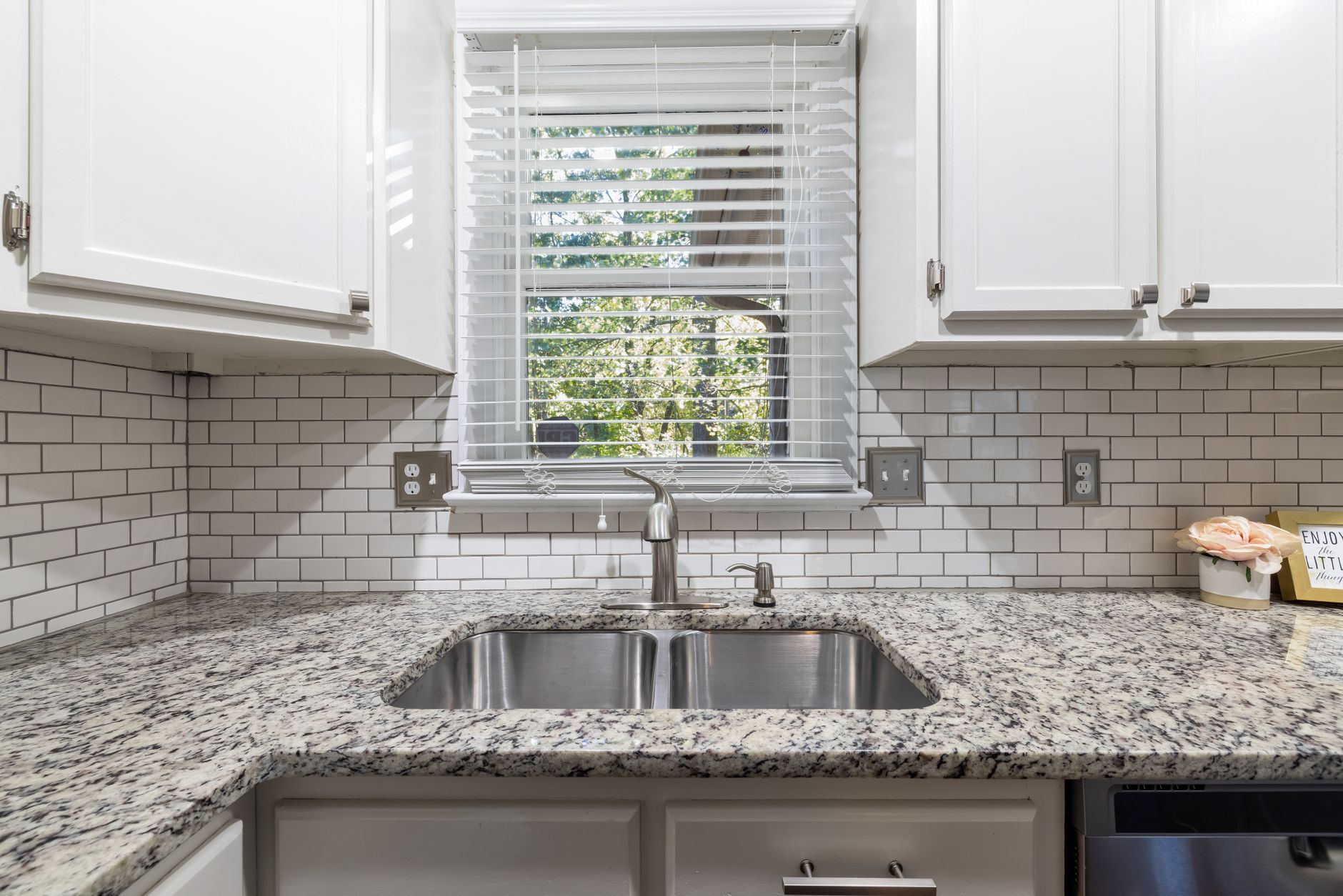 Spacious kitchen showcasing sleek cabinets, granite countertop, and a stainless steel sink in Lakewood, CA
